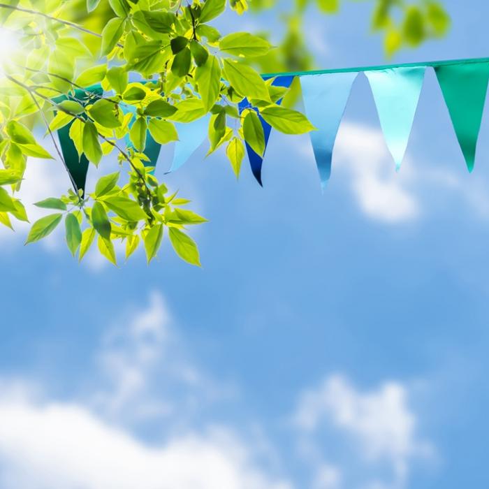 Looking up at colourful bunting against a blue sky