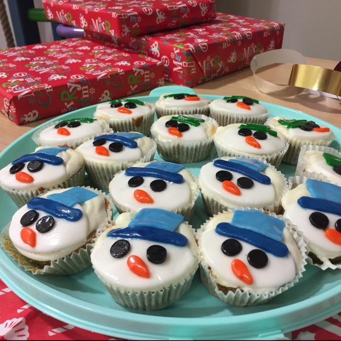 A plate of Christmas themed cup cakes